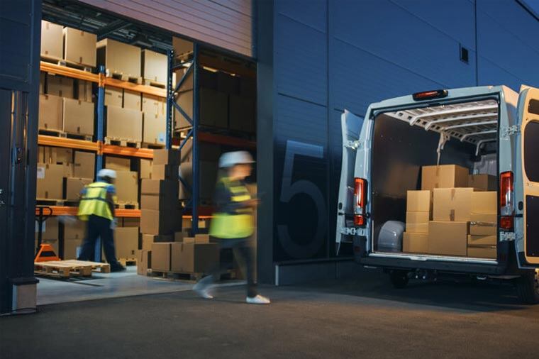 Crew loading packages into sprinter van