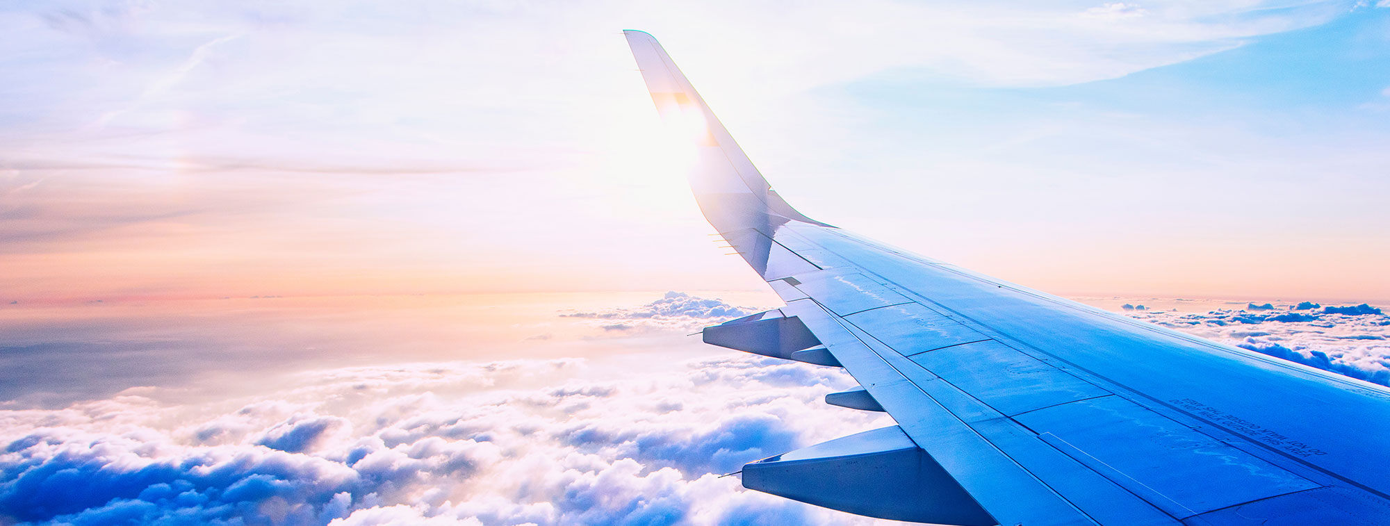 an airplane wing over clouds